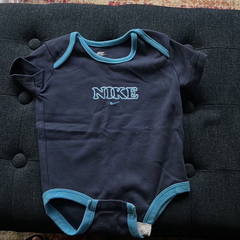 Nike onesies set of 4! Size 3-6 months. 2 navy blue, 1 red, 1 green. NWOT